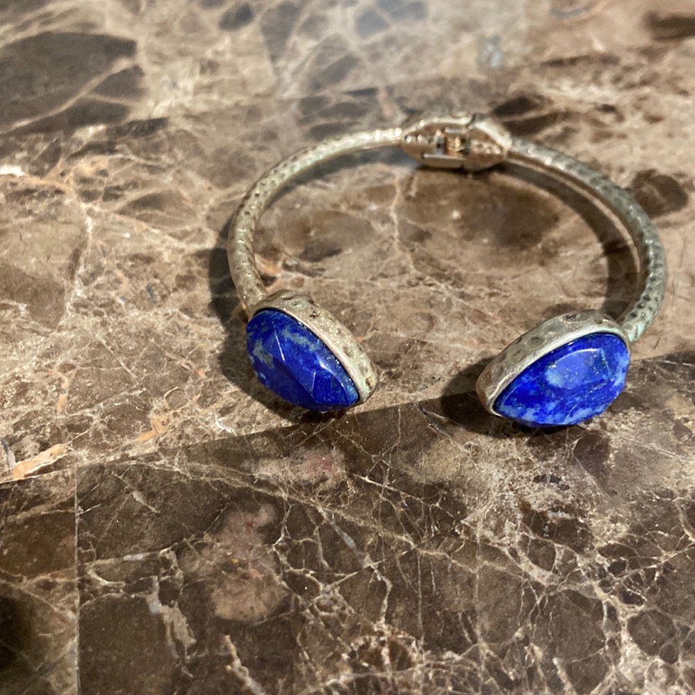 Gold tone bracelet with blue stone